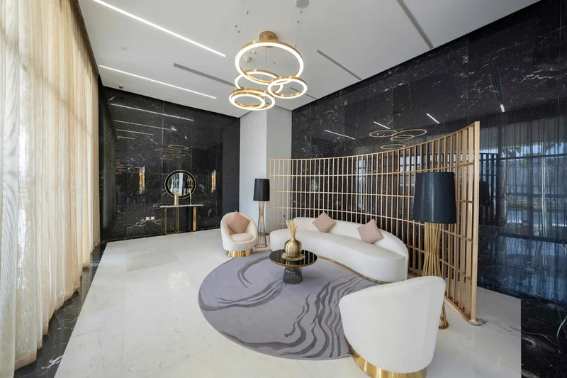 A living room with white furniture and a chandelier